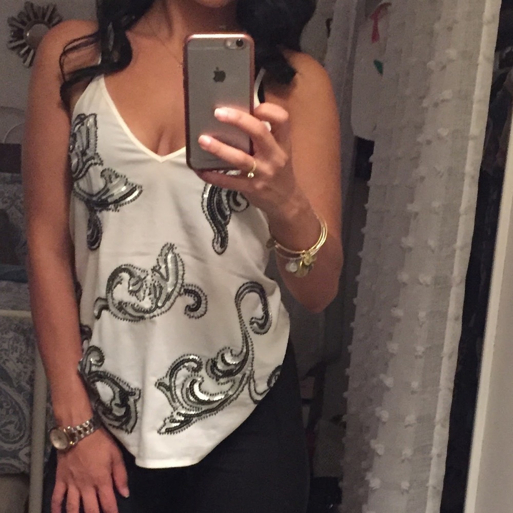 Off white top with black and silver sequins. V-neck and spaghetti strap.